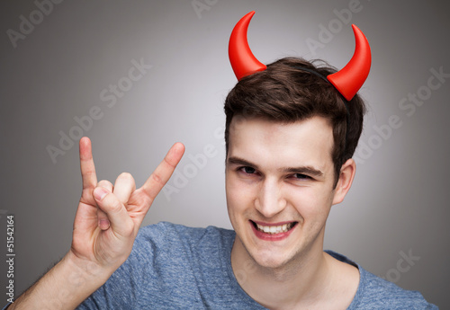 Photo: Man wearing devil horns Man wearing devil horns