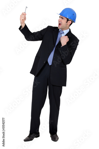 Photo: Businessman holding a key Businessman holding a key