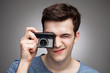Young man with vintage camera