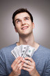 Man with money looking up