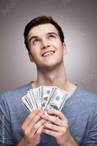 Photo: Man with money looking up Man with money looking up