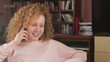 Young girl talking on a mobile phone, tracking shot