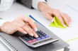 Hands working on the calculator