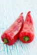 red peppers on painted board