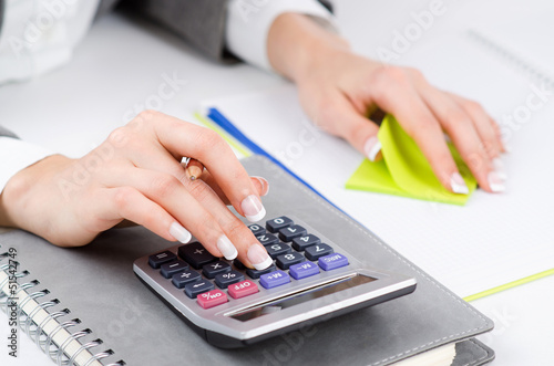 Photo: Hands working on the calculator Hands working on the calculator