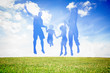 Silhouette of family jumping in the air