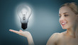 Big light bulb lighting inside hand