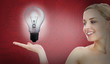Smiling woman with light bulb inside her hand