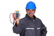 happy electrician showing multimeter