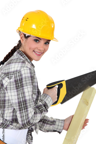 Photo: Woman sawing plank Woman sawing plank