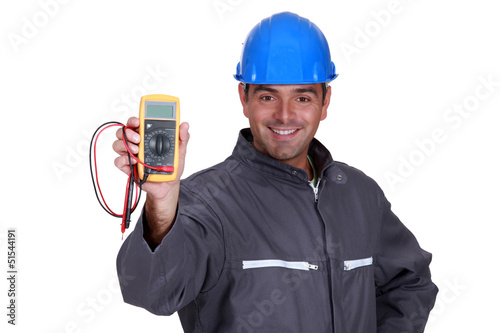 Photo: happy electrician showing multimeter happy electrician showing multimeter