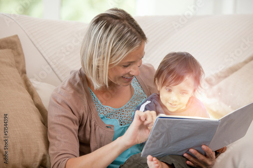 Photo: Mother and her son reading a glowing story together Mother and her son reading a glowing story together