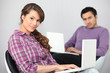 a young couple doing computer