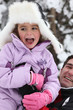Photo: Father and daughter having fun in the snow Father and daughter having fun in the snow