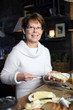 Woman spreading butter on a piece of bread