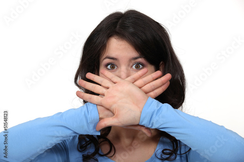 Photo: young brunette hiding her mouth young brunette hiding her mouth
