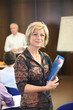 Foto: Woman holding a file during a presentation Woman holding a file during a presentation