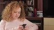 Young woman sending sms, tracking shot
