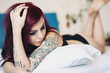 Photo: Sensual portrait of beautiful girl with tattoo lying on bed. Sensual portrait of beautiful girl with tattoo lying on bed.