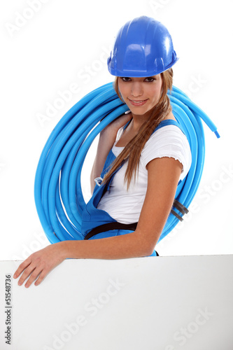 Photo: Young brunette with helmet and blue tube roll Young brunette with helmet and blue tube roll