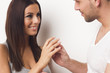 Young couple giving each other an engagement ring