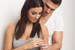 Young couple giving each other an engagement ring