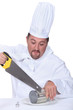 Photo: Chef sawing tin Chef sawing tin