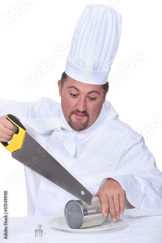 Photo: Chef sawing tin Chef sawing tin