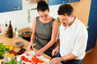 Couple cooking together in kitchen