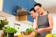 Couple cooking together in kitchen