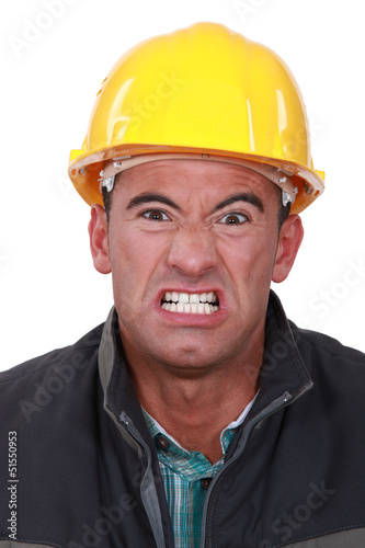 Photo: Angry builder grimacing Angry builder grimacing