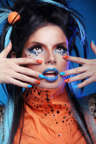 Photo: Nails Manicured. Make up. Close up of woman face with colorful m Nails Manicured. Make up. Close up of woman face with colorful m