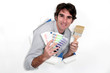 Man holding paint brush and swatch