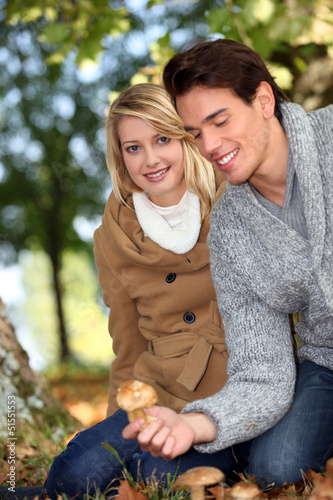 Photo: Couple picking mushrooms together Couple picking mushrooms together