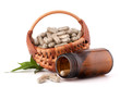 Herbal drug capsules in wicker basket. Alternative medicine conc