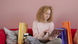 Young woman looking worried over bills, tracking shot