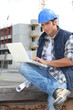 Foto: Builder on site with a laptop Builder on site with a laptop