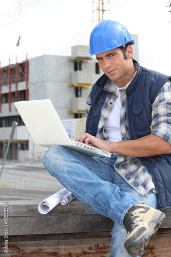 Photo: Builder on site with a laptop Builder on site with a laptop