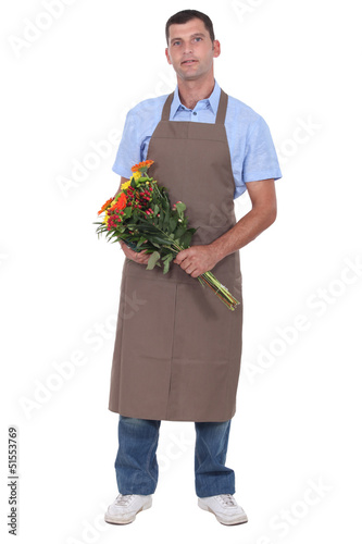Photo: Full length studio shot of a male florist Full length studio shot of a male florist