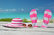 Hat, sunglasses and flip-flops against ocean. Exuma, Bahamas