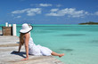 Girl on the wooden jetty looking to the ocean. Exuma, Bahamas