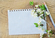 flowers and note on wooden background
