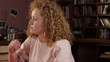 Young pensive woman sitting in the room, tracking shot