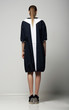 Rear View of of Trendy Woman in White-Black Contrast Raincoat