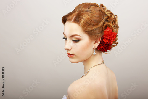Photo: Bride. Golden Hair Female with Red Flower. Platinum Necklace Bride. Golden Hair Female with Red Flower. Platinum Necklace