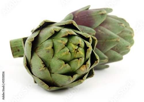 Photo: two artichoke over white two artichoke over white