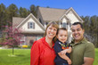 Mixed Race Young Family in Front of House