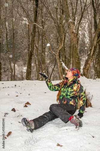 Photo: Beautiful woman in ski suit in snowy winter outdoors Beautiful woman in ski suit in snowy winter outdoors