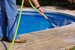 Hosing poolside pathway, Spain © Arena Photo UK