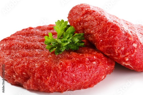 Photo: Raw beef and vegetables on white background Raw beef and vegetables on white background